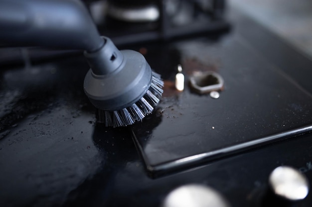 cleaning and disinfection of the apartment with a steam cleaner cleaning the stove