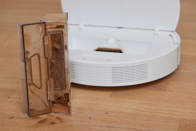 Cleaning the filter of the vacuum robot cleaner from dirt closeup