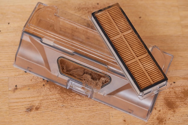 Cleaning the filter of the vacuum robot cleaner from dirt closeup