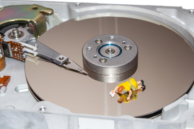 Cleaning the hard disk A woman cleans a HDD Figurine of a woman Cleaners