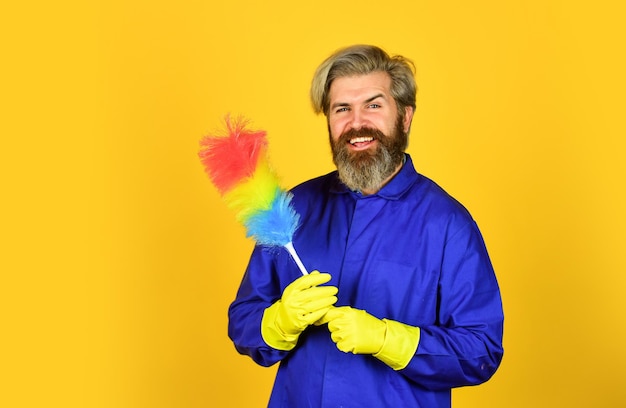 Cleaning and home concept Male Sweeping with small duster broom cleaning service housekeeping business Cleaning the apartment man use duster hipster holding the cleaning tool Unfair situation