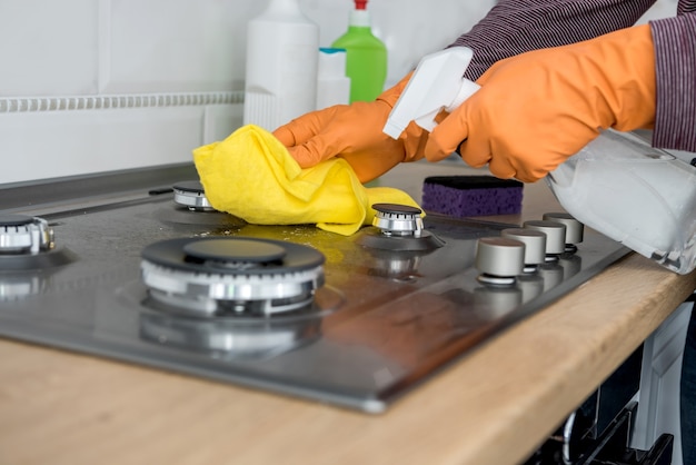 Cleaning in the kitchen gas stone with foam and sponge. Domestic equipment for health lifestyle