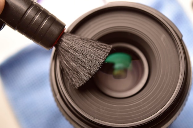 Cleaning lens with brush