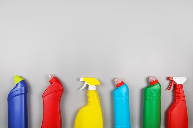 Cleaning products on grey background. Home cleaning concept. Top view