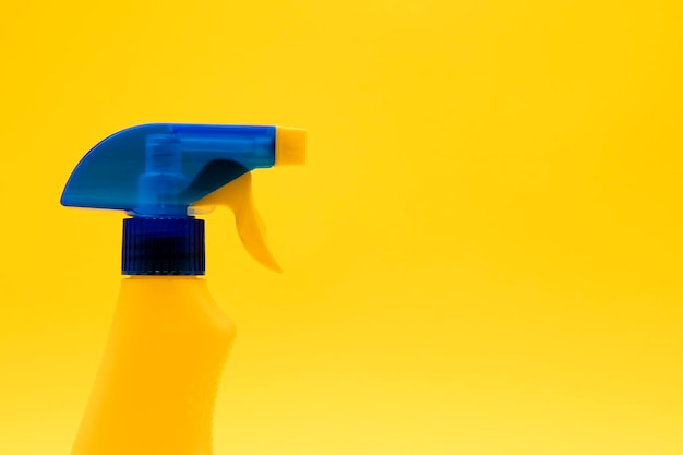 Cleaning spray bottle products on a bright yellow background