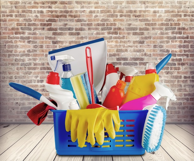 Cleaning supplies in blue  plastic basket