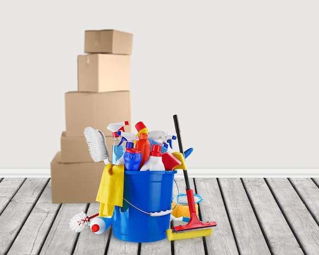 Cleaning supplies with moving boxes on background