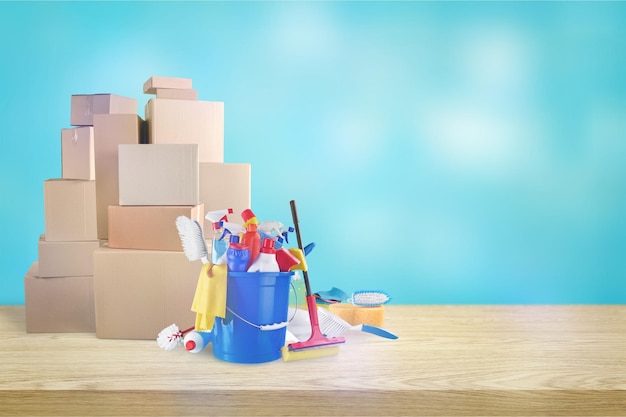 Cleaning supplies with moving boxes on background