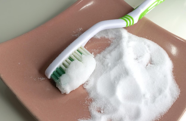 Cleaning teeth with toothbrush and baking soda