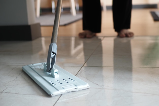 Cleaning tiles floor with mop