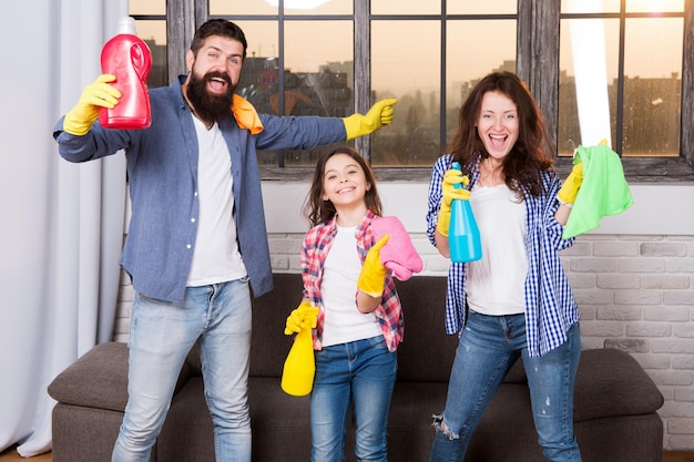 Cleaning together easier and more fun Family care about cleanliness Start cleaning Cleaning day Family mom dad and daughter with cleaning supplies at living room We love cleanliness and tidiness