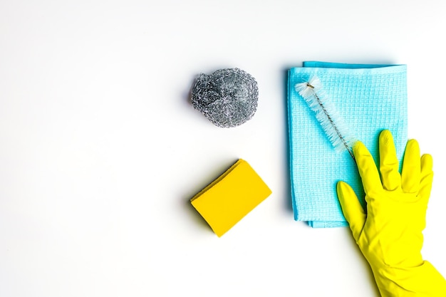 Cleanliness and cleaning blue rag yellow sponge and brush females hand in yellow gloves