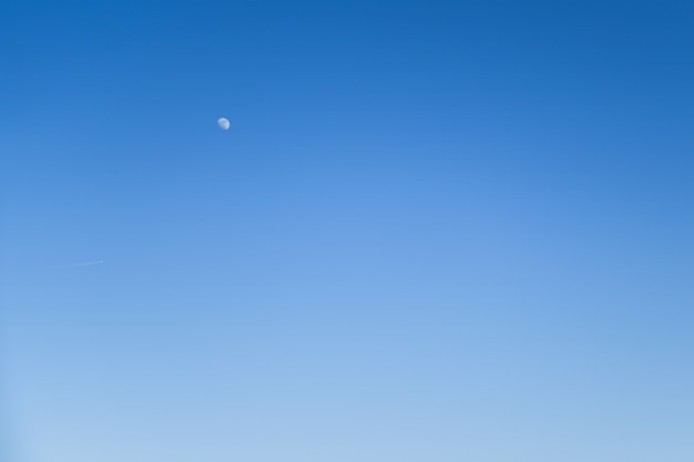 Clear blue sky without clouds with moon