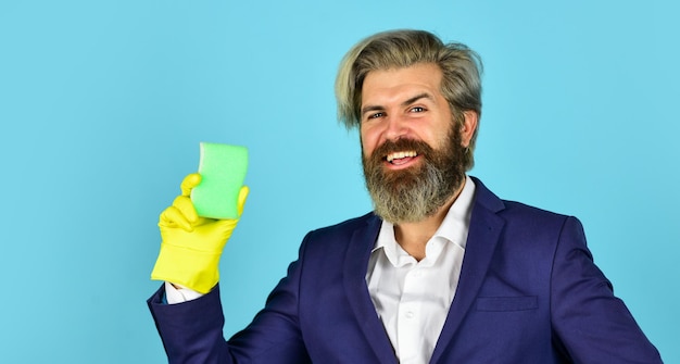 clear business. housekeeping and cleaning concept. House cleaning. bearded man doing housework and cleaning. handsome businessman with washing gloves. use sponge and detergent for floor cleaning.