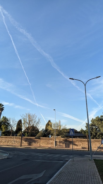 On a clear cloudless day in Lisbon you can see a lot of traces of airplanes against the background o