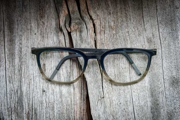 Clear eyeglasses, Glasses transparent dark blue frame Vintage style on grungy wood background