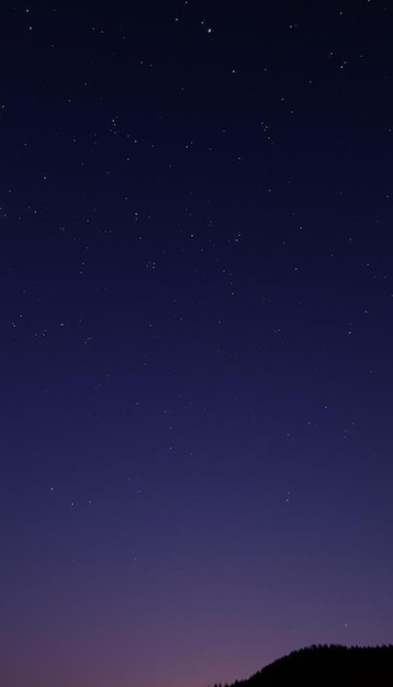 a clear night sky with stars and a building in the background