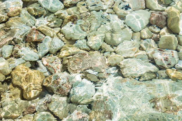 Clear sea, stone beach. Summer. Pattern. Background.