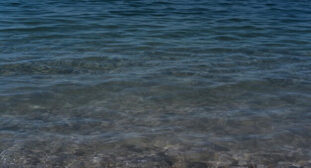 Clear sea water and rocks on the bottom Black sea with blue and emerald green water