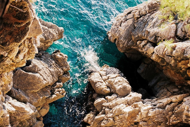 Clear turquoise water at the foot of the rocks top view