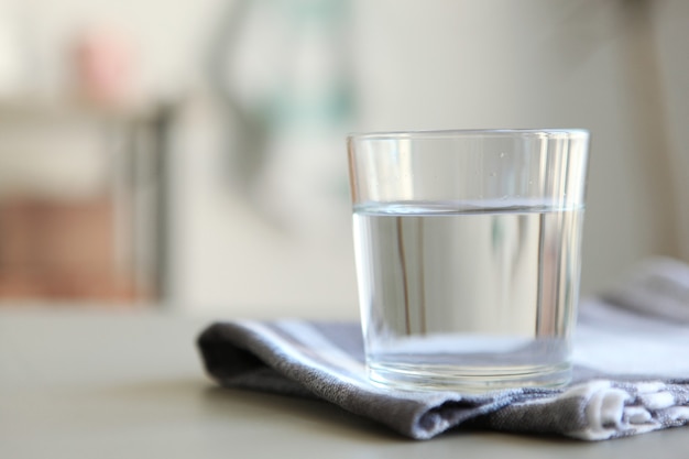 Clear water in a glass and bottle on the table