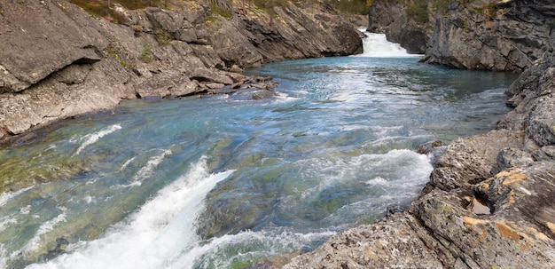 Clear water of a stremo flowing between the rocks in Norway