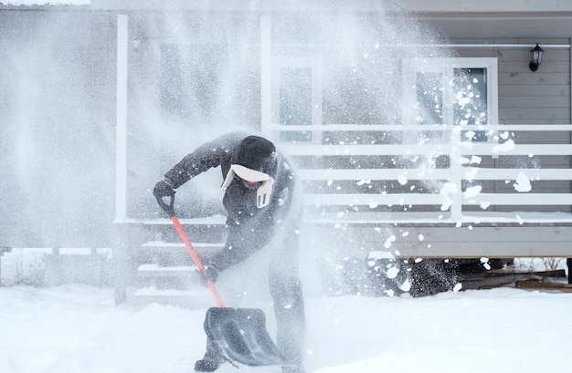 Clearing snow near the house after a heavy snowfall