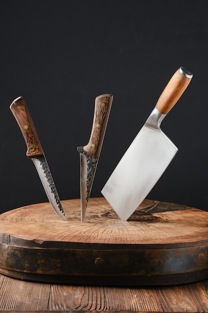 Cleaver and two meat knives sticking out of wooden blockhead