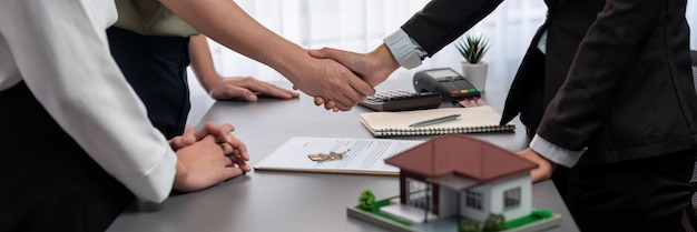 Photo client and real estate agent shake hand after signing house loan deal prodigy