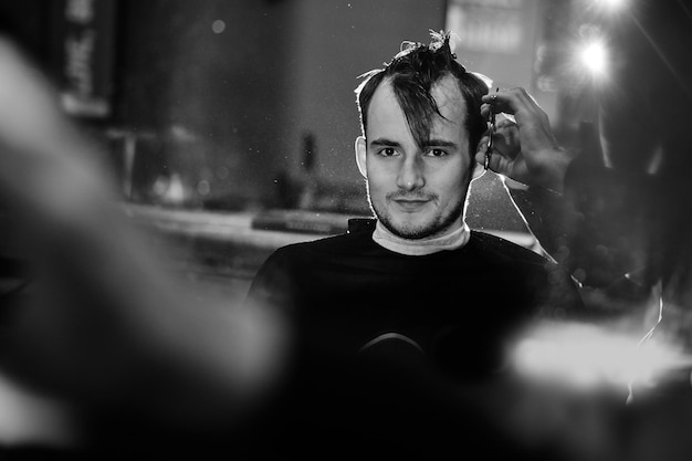 The client at the time of shearing in the Barber shop, black and white photo