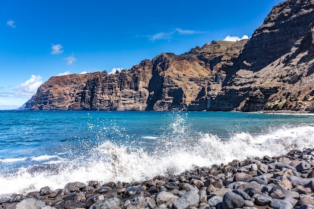 Cliffs and  beach stones on the Atlantic Ocean Coastline Los Gigantes Tenerife Canary Islands Spain