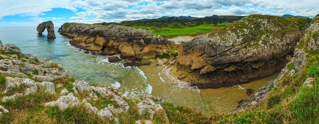 Cliffs and canyon in town of Llanes Villahormes, the islet known as Castro de las Gaviotas (Asturias, Spain). Three shots stitch panorama.