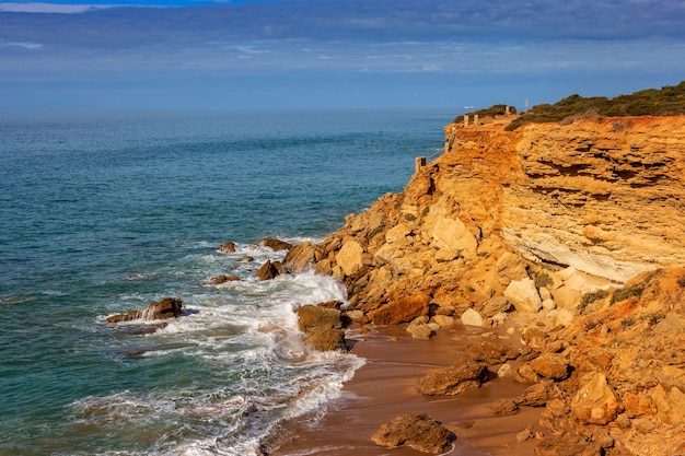 Cliffs with dangerous staircase to the beach in the background