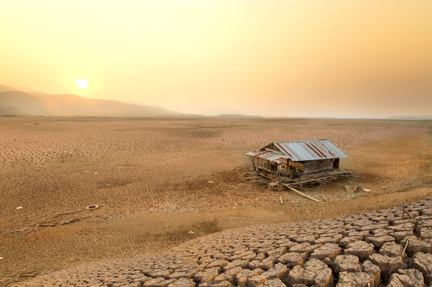 Climate Change Dry lake and House raft on  cracked earth