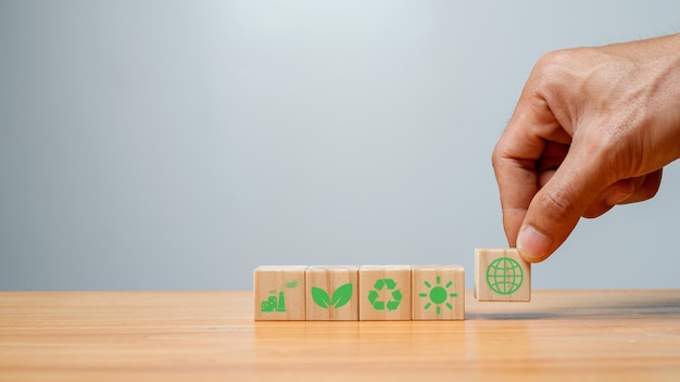 Climate neutral long term strategy Hand put wooden cubes with decrease carbon emission icon and green iconLow carboncarbon neutral concept Green banner