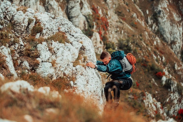 Climber overcoming a difficult climbing route on the rock mountain Adventure extreme sport outdoor