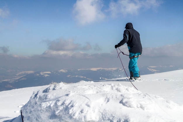 Climber prepares to descend from snowcovered mountain