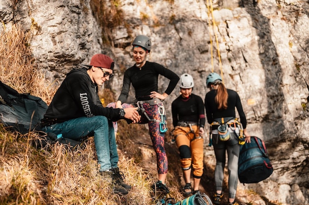 Climber wearing in climbing equipment Practicing rockclimbing on a rock mountain wall Climbing sports and bouldering concept rock climber climbs on a rocky wall