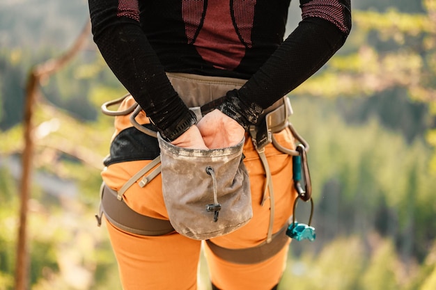 Climber wearing in climbing equipment Practicing rockclimbing on a rock mountain wall Climbing sports and bouldering concept rock climber climbs on a rocky wall