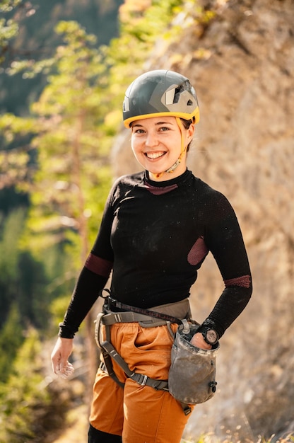 Climber wearing in climbing equipment Practicing rockclimbing on a rock mountain wall Climbing sports and bouldering concept rock climber climbs on a rocky wall