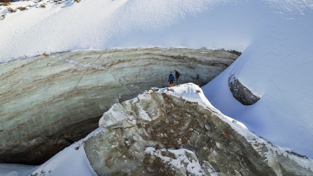 Climbers are standing on top of a glacier