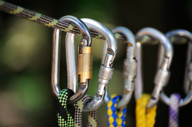 Climbing sports image of a carabiner on a rope in a forest