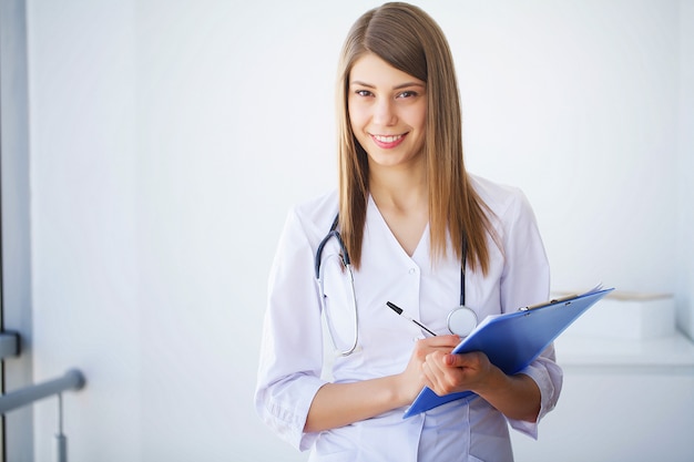 Clinic. Portrait of young doctor standing in medical clinic