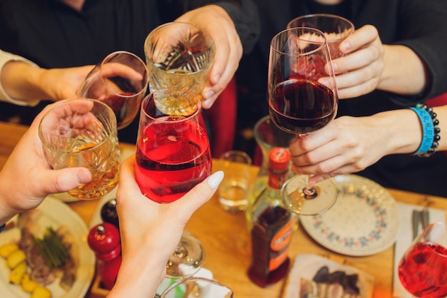 Clinking glasses with alcohol and toasting party