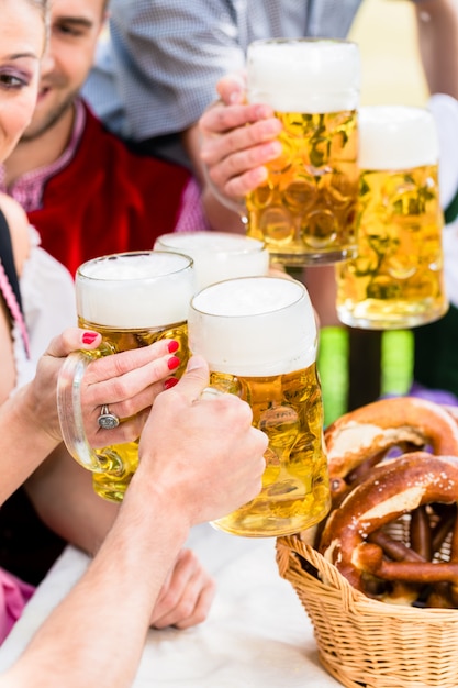 Clinking glasses with beer in Bavarian pub