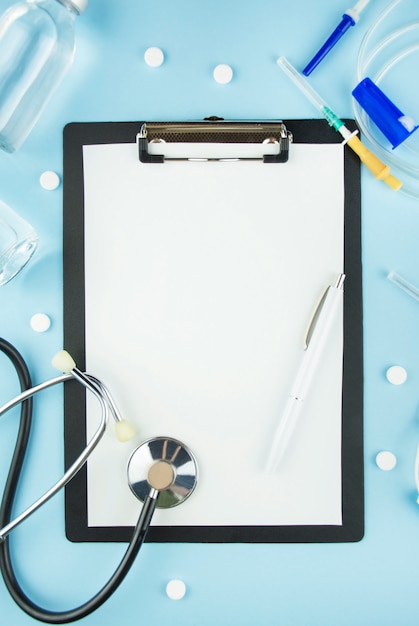 Clipboard with stethoscope and pills