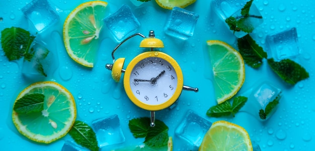 Clock and ice cubes Vacation and daylight saving time concept Selective focus