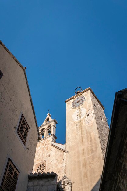 Clock tower and bell tower of the church of Saint Rocco in the old town of Omis, Croatia