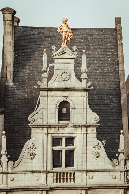 a clock tower with a statue on top of it