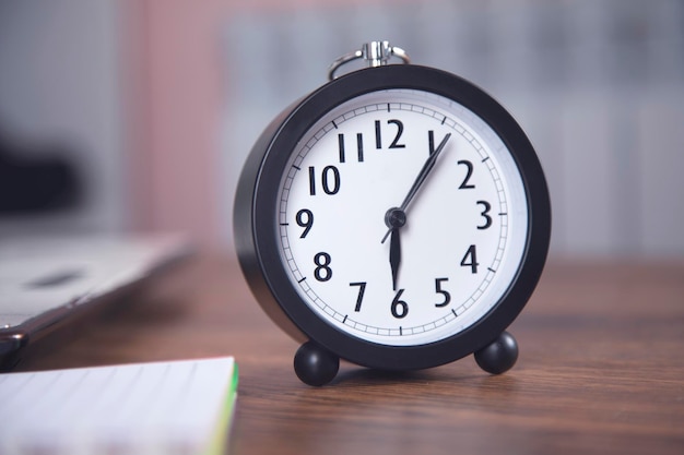 Clock with computer on the table